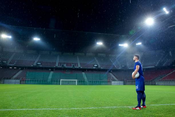 istock Football player standing in stadium 647629920