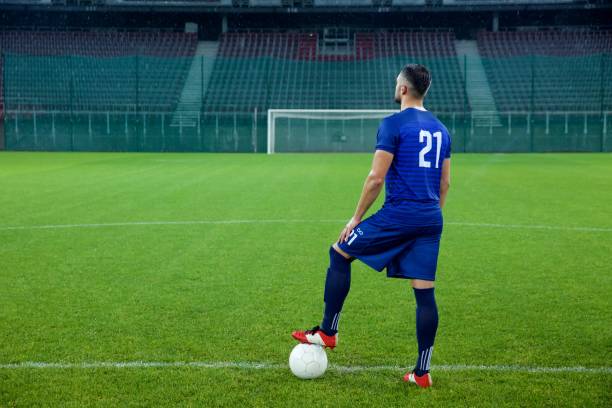 istock Football player standing in stadium 647629922