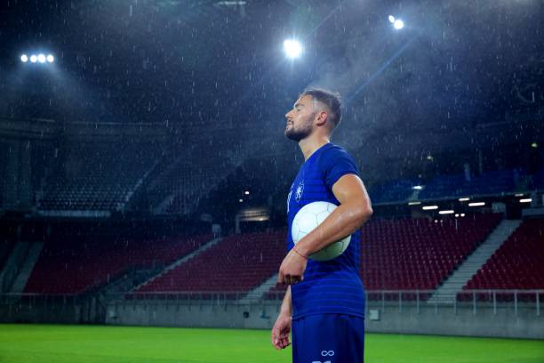 istock Football player standing in stadium 647629924