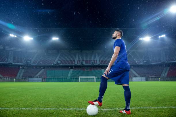 istock Football player standing in stadium 647629944
