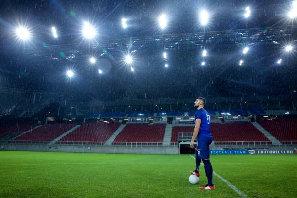 istock Football player standing in stadium 647629950