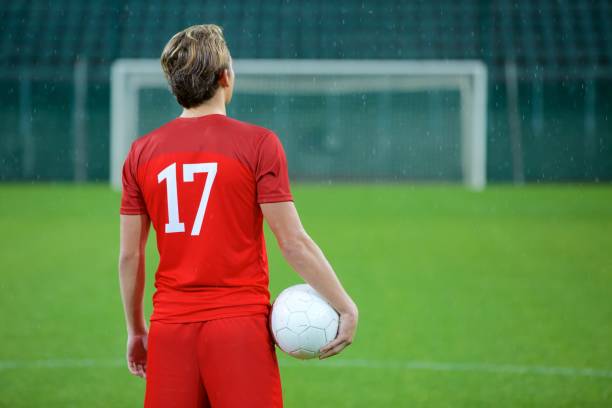 istock Football player standing in stadium 647629956