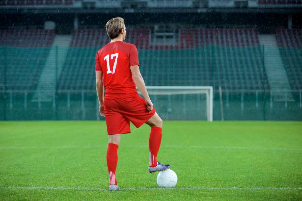 Football player standing in stadium