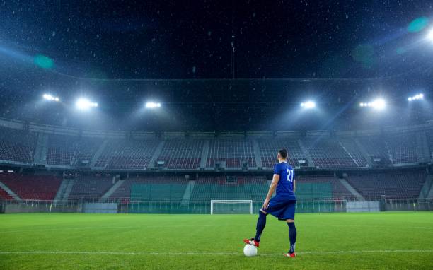 istock Football player standing in stadium 647629966