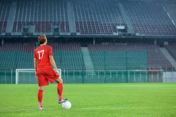 istock Football player standing in stadium 647629968