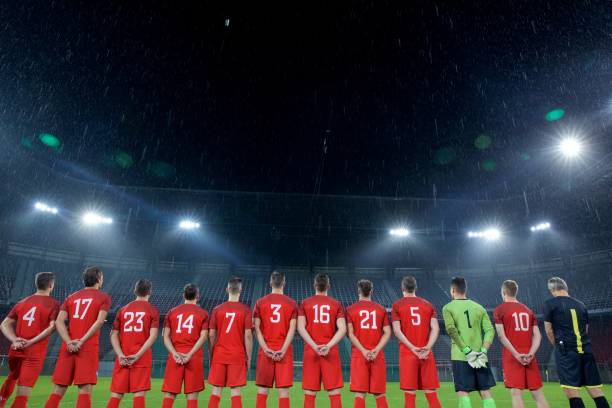 istock Football team standing in a row 647629970