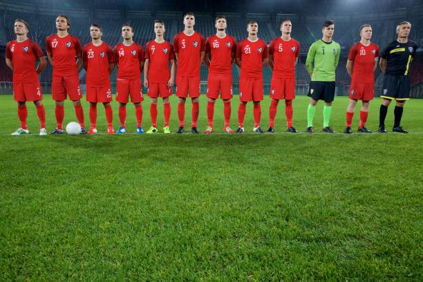 istock Football team standing in a row 647629972