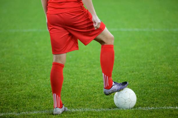 istock Football player standing in stadium 647629978