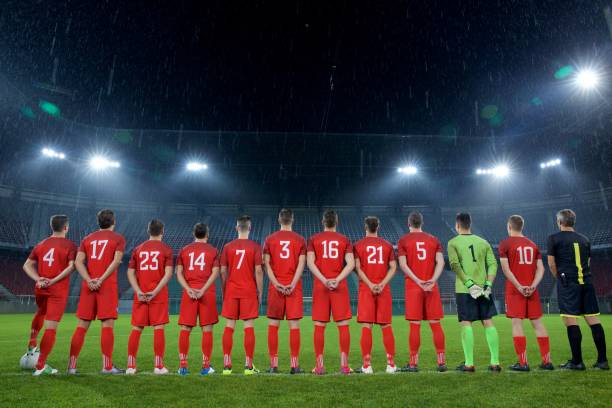 istock Football team standing in a row 647629980