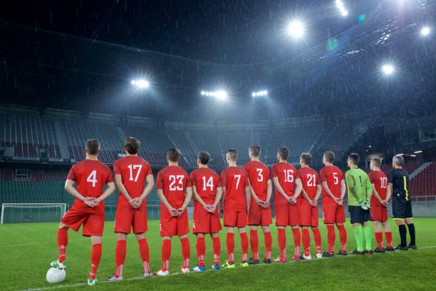 istock Football team standing in a row 647629992