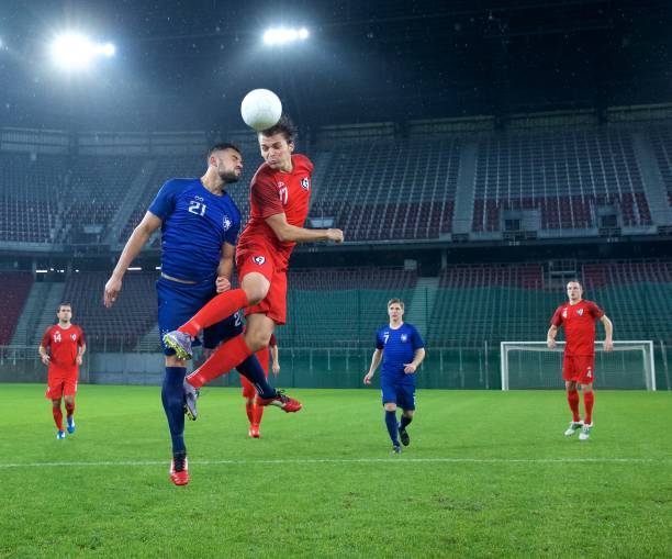 Soccer players heading Football player jumping and heading the ball. heading stock pictures, royalty-free photos & images
