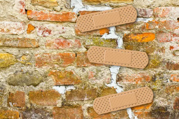 Photo of Renovation of cracked brick wall - concept image with copy space