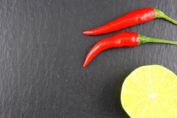 istock fresh thai chili peppers and lime on a slate plate 647634090
