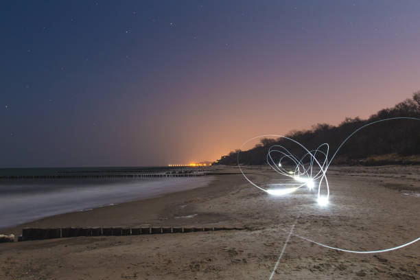 istock Strange futuristic light trails on beach 647636462
