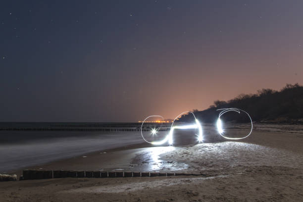 istock Light painting word cao on the beach 647636474