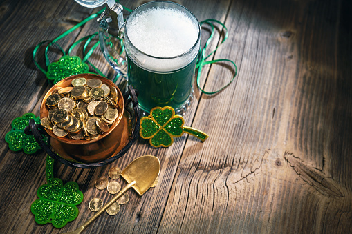 St. Patricks Day concept with gold coins, green beer and clover leaf