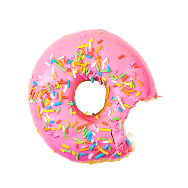 Bitten strawberry donut with colorful sprinkles. Top view.