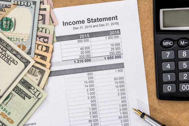 Save money concept - doc income statement with pen, calculator and money. Save money concept - doc income statement with pen, calculator and money. bank statement stock pictures, royalty-free photos & images