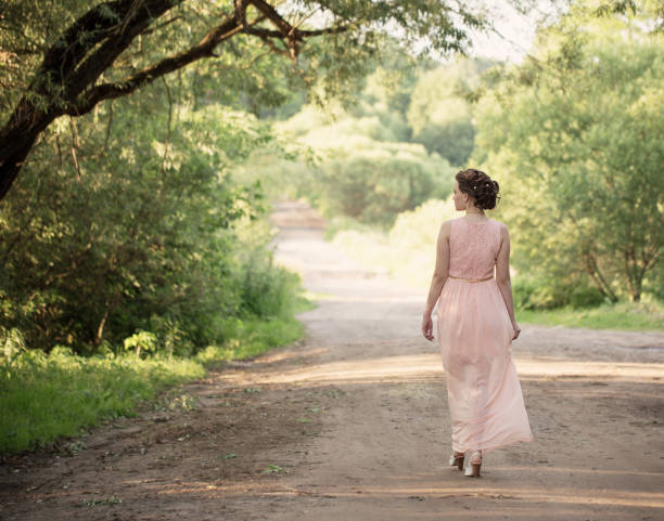 istock beautiful girl in summer park 647654038