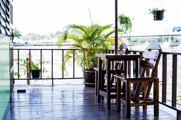 istock Chairs with wooden table on the terrace 647656936