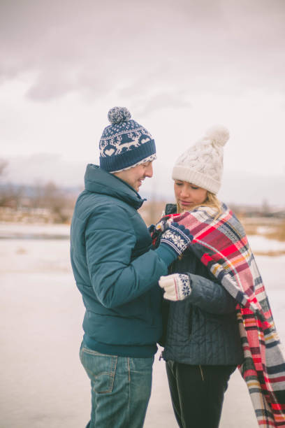 istock Couples holding each other on the shore of lake 647659648