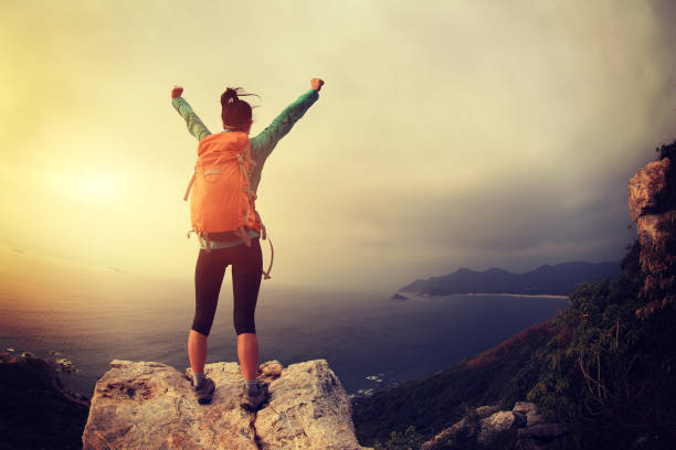 istock successful hiker hiking on seaside mountain peak 647661876