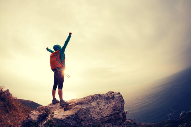 istock successful hiker hiking on seaside mountain peak 647661922