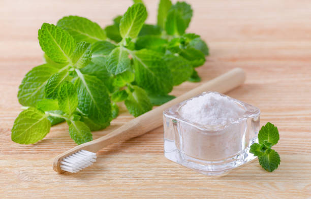 alternative natural toothpaste himalayan salt and wood toothbrush, mint on wooden