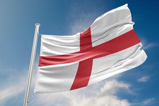 English flag is waving at a beautiful and peaceful sky in day time while sun is shining.