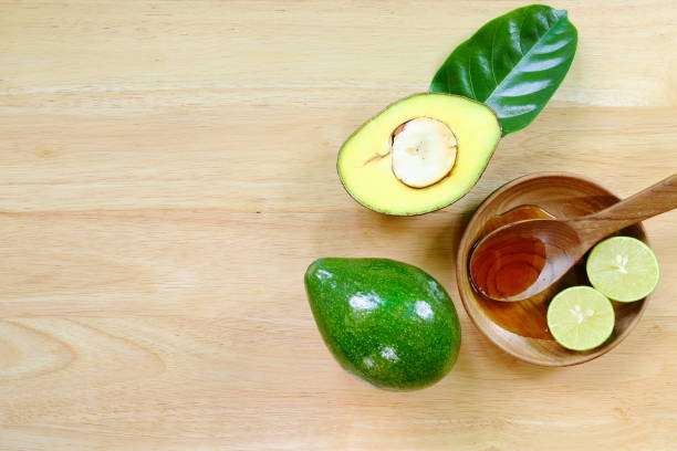 Fresh avocado fruits on a wood background. stock photo