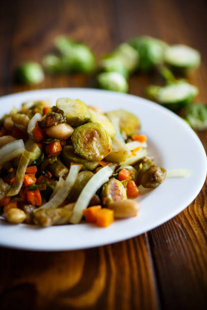 istock Brussels sprouts roasted with vegetables and beans 647677278