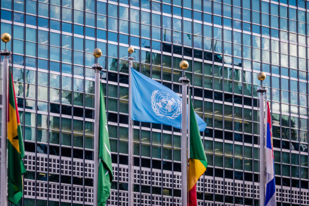 NEW YORK, USA - December 08, 2016: World and UN Flags in front  at United Nations Headquarters in Manhattan