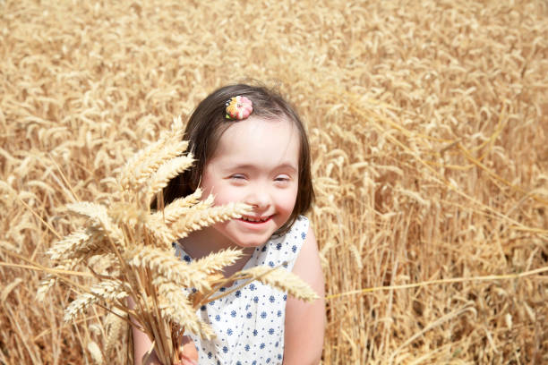 istock Down syndrome girl in the wheat field 647684964