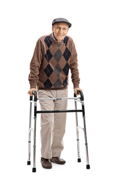 Happy senior using a walker Full length portrait of a happy senior using a walker isolated on white background mobility walker stock pictures, royalty-free photos & images