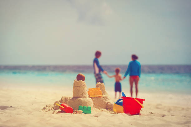 istock sand castle on tropical beach, family vacation 647687856