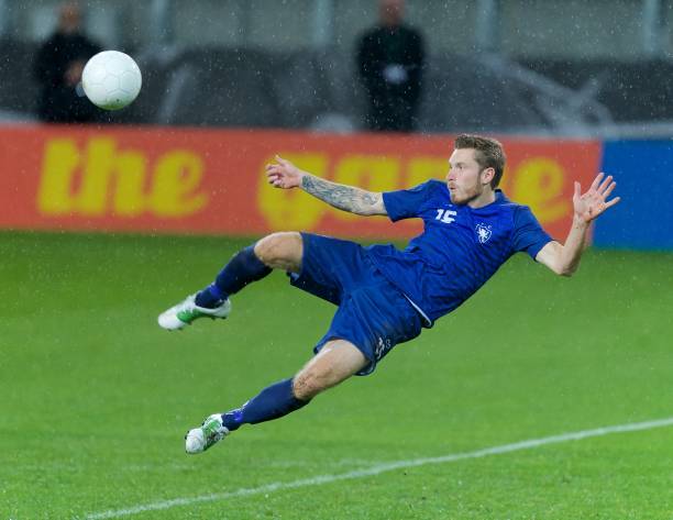 istock Football player kicking 647702324