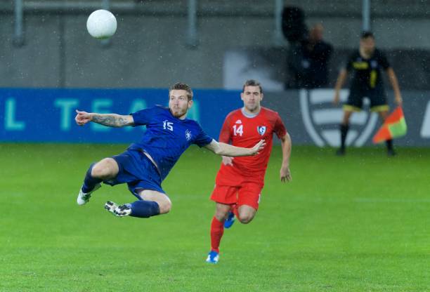 istock Football player kicking 647702350