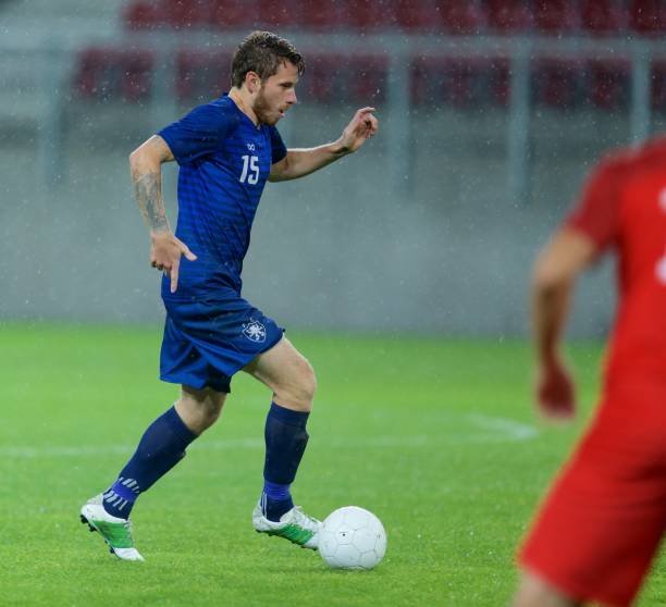 istock Football player with ball 647702356