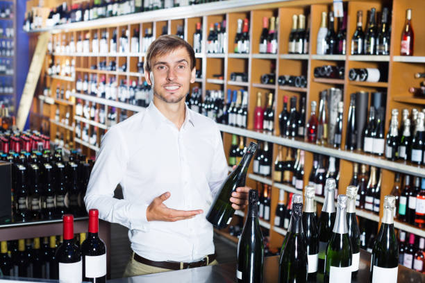 istock Cheerful man buying bottle of wine 647704130
