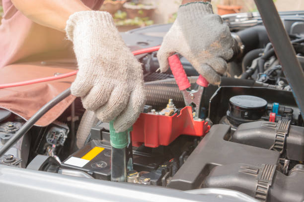 istock Charging battery car with electricity trough jumper cables 647706344