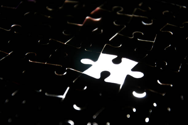 istock A creative completes the black puzzle putting the last missing piece blue light 647707182