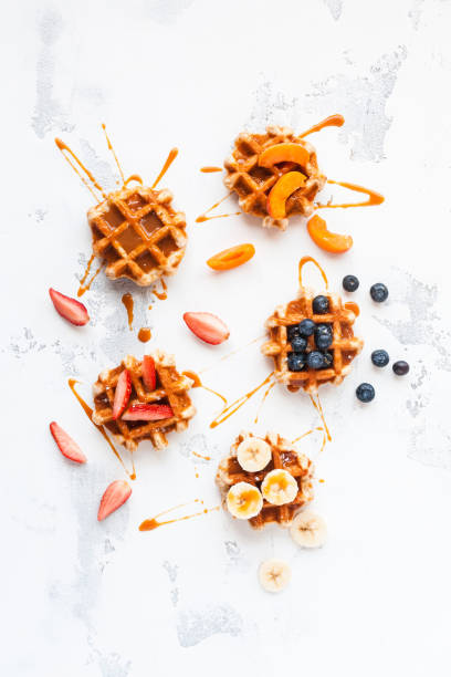 istock Traditional belgian waffles with fresh fruit and caramel 647715582
