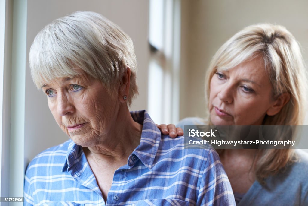 Serious Senior Woman With Adult Daughter At Home Senior Adult Stock Photo