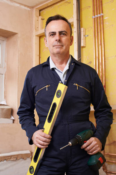 istock Portrait Of Builder With Spirit Level And Electric Drill 647724204