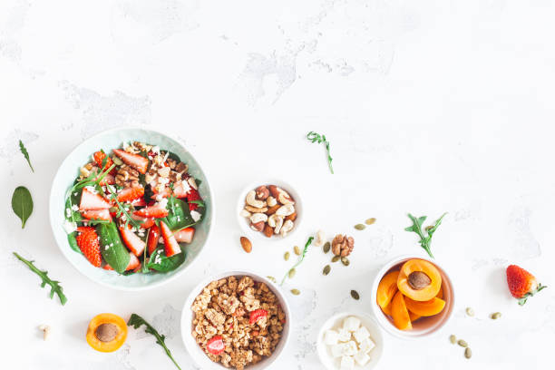 istock Breakfast with muesli, strawberry salad, fresh fruit, nuts 647724308