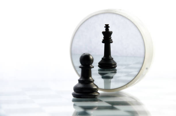 pawn pieces on the chessboard, the reflection in the mirror king, often in life things and people are not what they seem