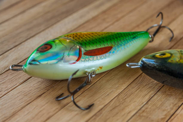 istock Fishing lures on a wooden background 647725734