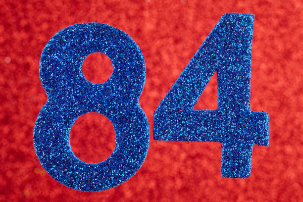 istock Number eighty-four blue color over a red background. Anniversary. 647732084
