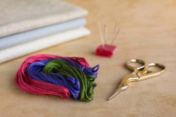 istock Embroidery and cross-stitch kit on a natural linen background. 647735334