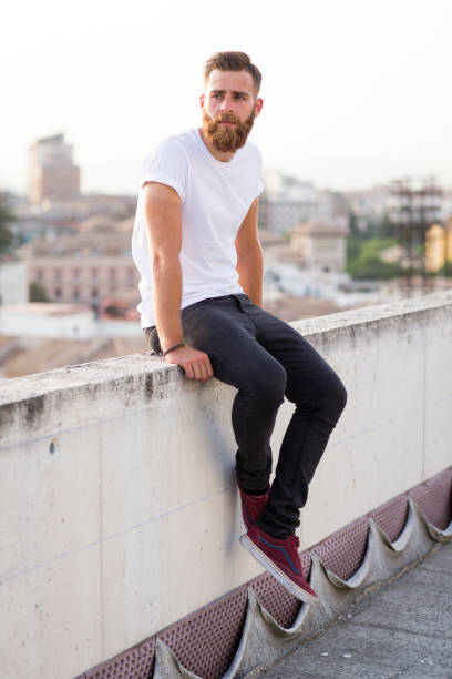 istock Bearded man sitting in the wall. 647739350